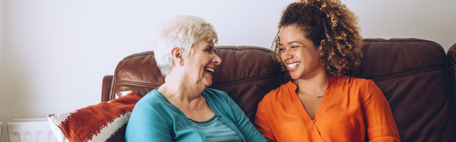 caregiver and elderly woman smiling