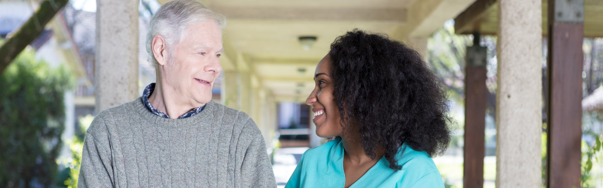 elderly man and nurse smiling